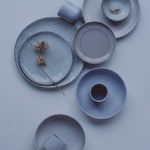 A white table topped with plates and cups