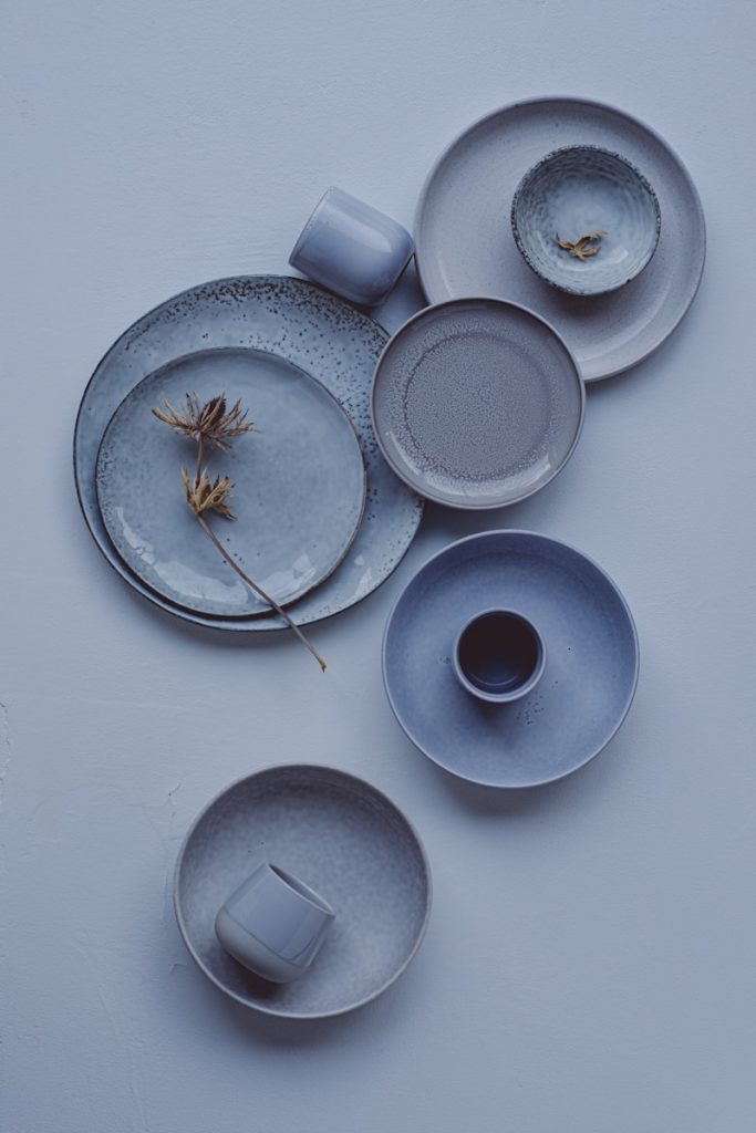 A white table topped with plates and cups
