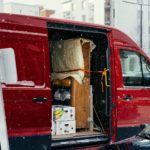A red van is parked on the side of the road