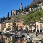 a row of buildings next to a body of water